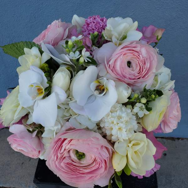 Pink and white mixed bouquet with orchids and ranunculus