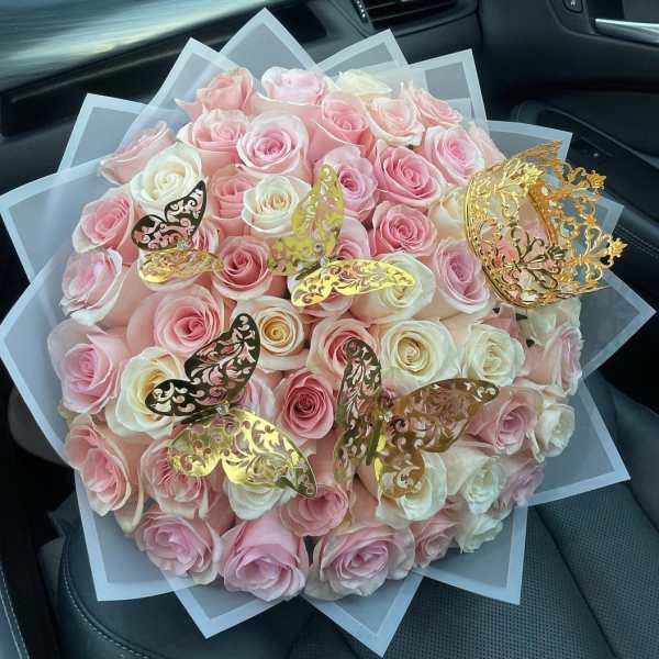 Bouquet of pink and white roses with gold butterfly decorations