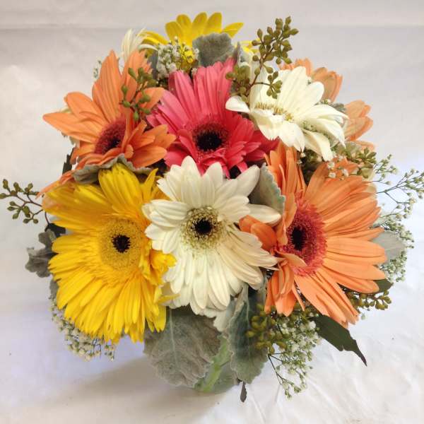 Bouquet of colorful gerbera daisies in a glass vase