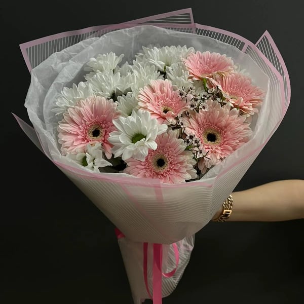 Bouquet of pink and white gerbera daisies wrapped in pink paper