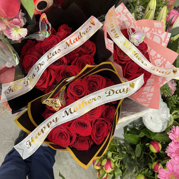 Bouquets of red roses with Mother's Day ribbons and butterfly decorations