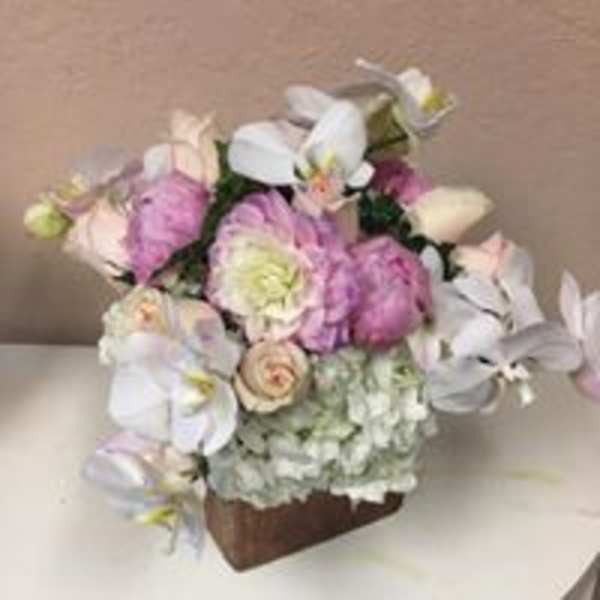 Bouquet of pink and white flowers in a brown container