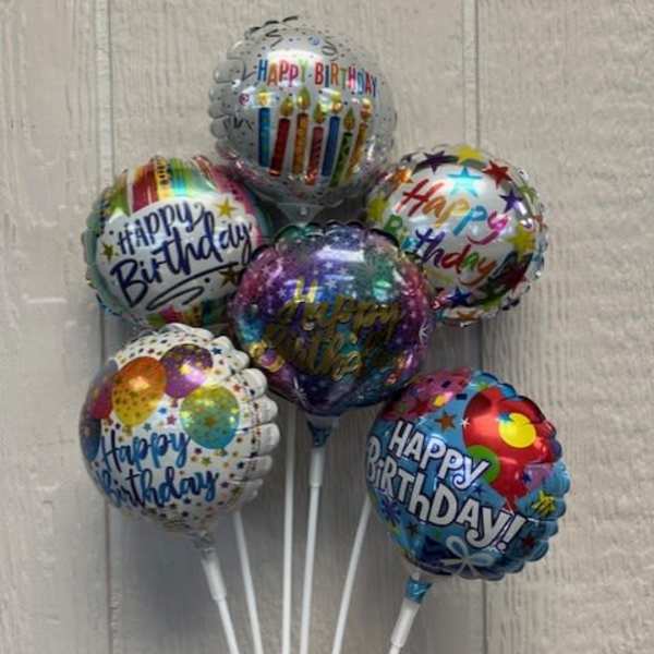 Cluster of birthday balloons with colorful printed designs