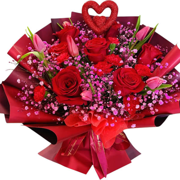 Bouquet of red roses and pink tulips with a glitter heart topper