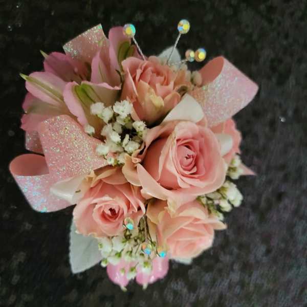 Pink rose bouquet with glittery wrap and small white filler flowers