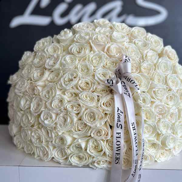 Large dome bouquet of white roses with a printed ribbon bow