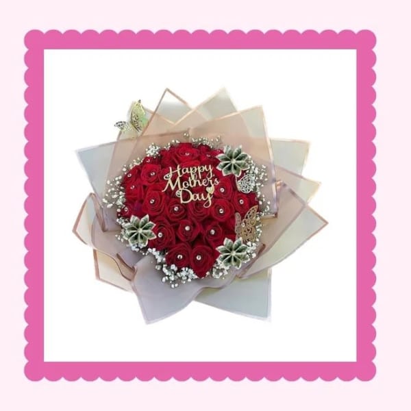 Heart-shaped bouquet of red roses with a Happy Mother's Day topper