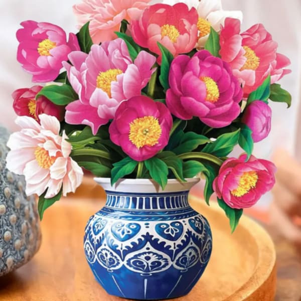 Pink and white peony bouquet in a blue patterned vase