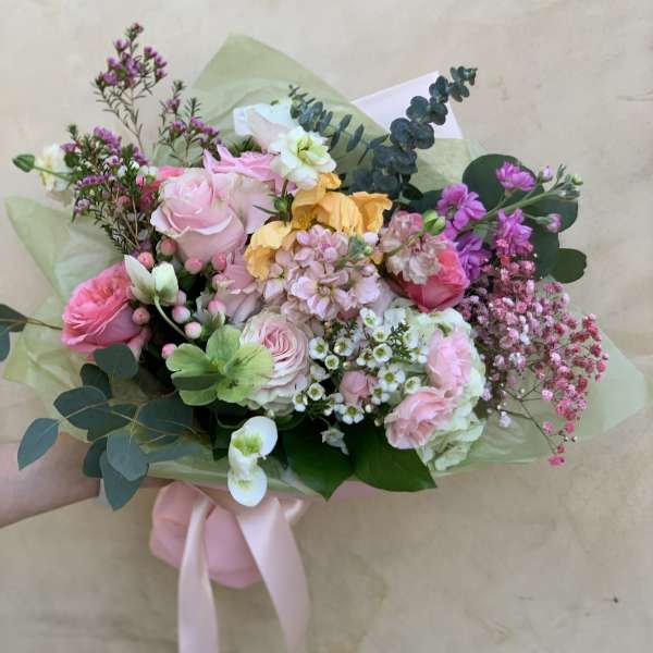 Hand-tied bouquet of pink, white, and yellow flowers with eucalyptus