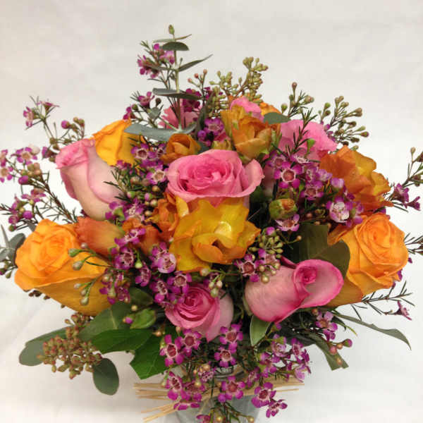 Bouquet of pink and orange roses in a glass vase