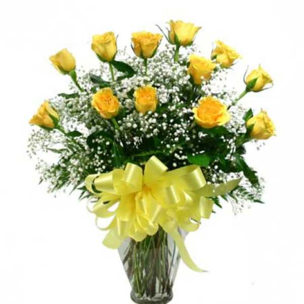 Yellow roses in a glass vase with baby's breath and a yellow bow