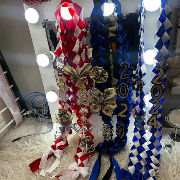 Decorative ribbon garlands with 2024 numbers and dollar-bill bows