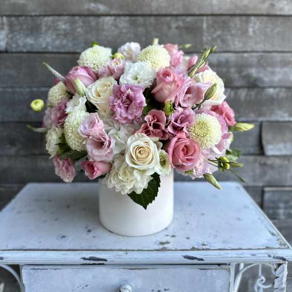 Pink and white bouquet in a white vase