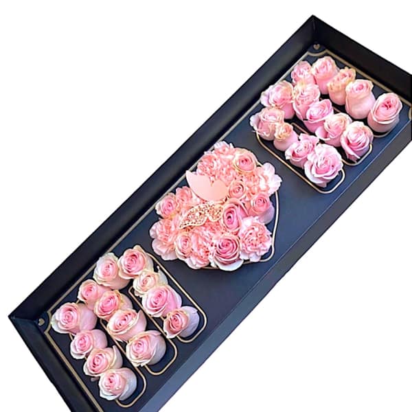 Pink roses arranged in a black presentation box