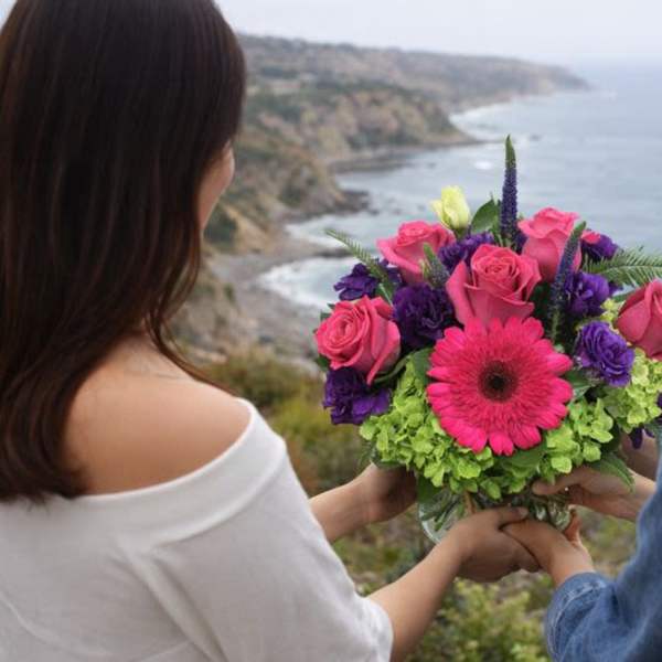 Bouquet of pink roses, purple blooms, and a pink gerbera daisy