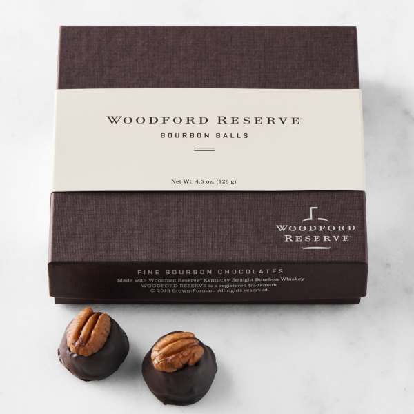 Box of Woodford Reserve bourbon balls with two chocolates in front