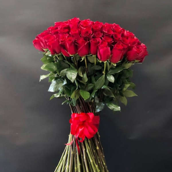 Large bouquet of red roses tied with a red ribbon