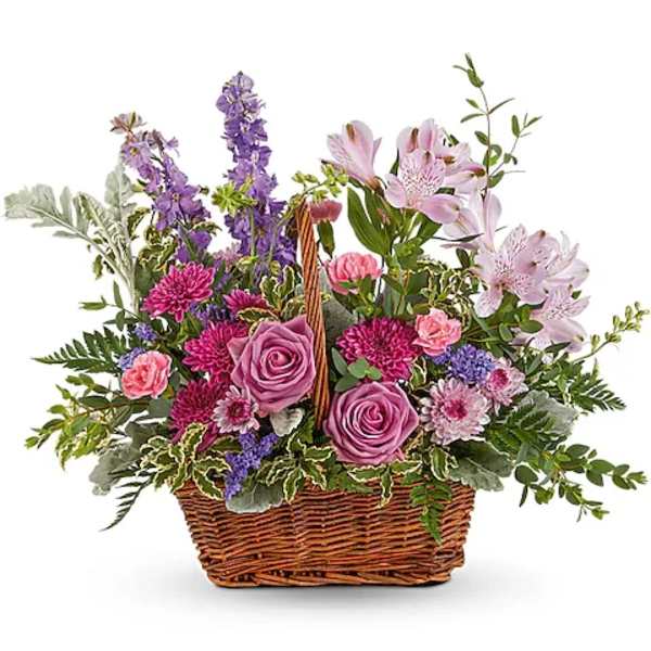 Mixed flower basket with pink and purple blooms in a wicker basket