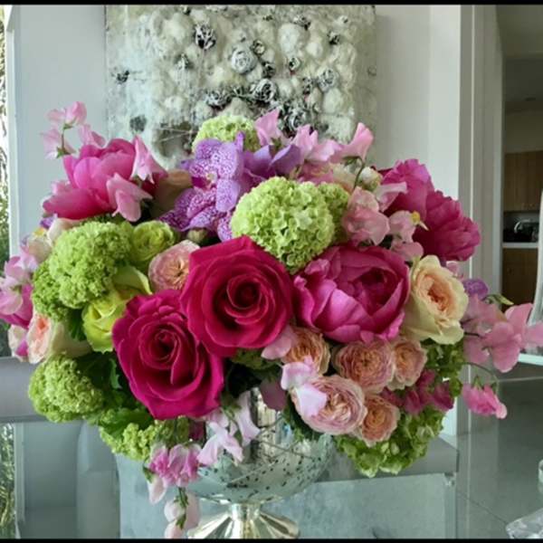 Pink and green floral arrangement in a glass vase