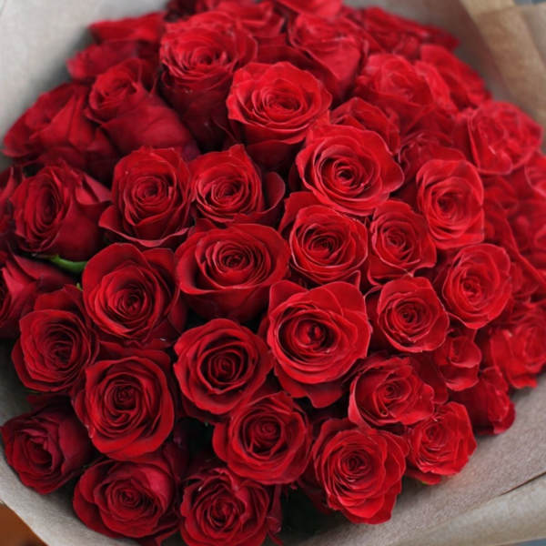Large bouquet of red roses wrapped in paper