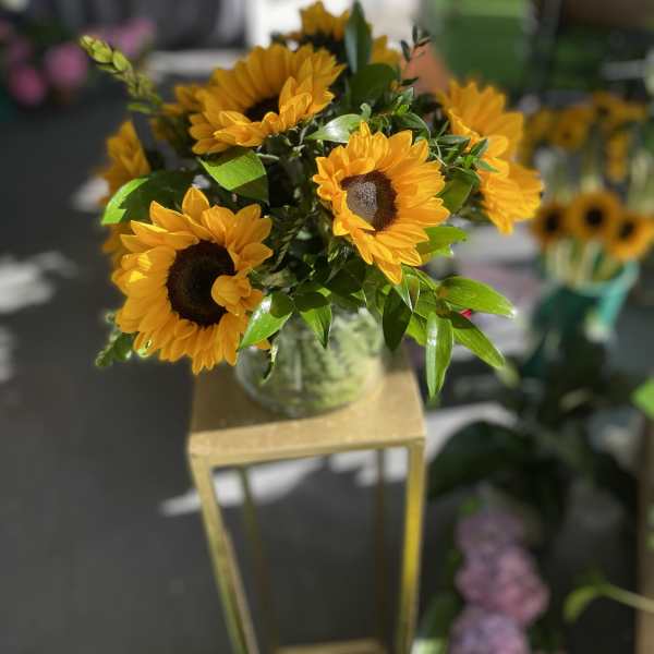 Bouquet of yellow sunflowers in a glass vase