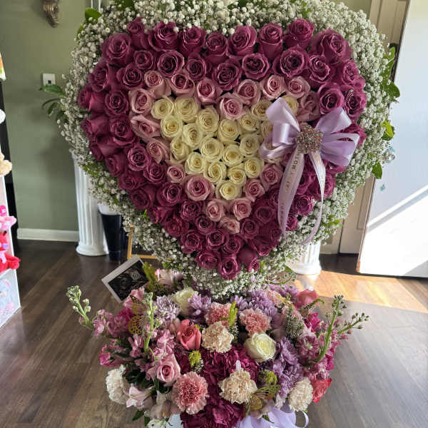 Heart-shaped rose arrangement with a smaller mixed flower bouquet below