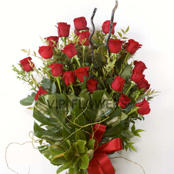 Bouquet of red roses with greenery and a red ribbon