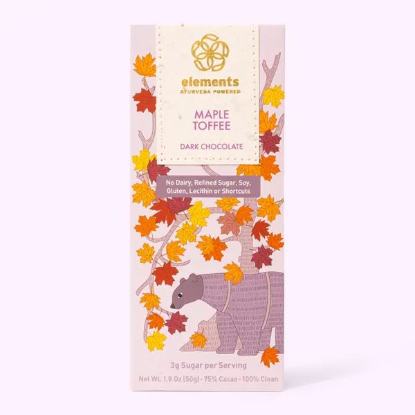 A maple toffee dark chocolate bar package with autumn leaves and a bear illustration