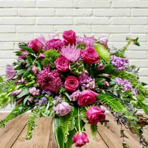 Pink and purple floral arrangement in a glass vase