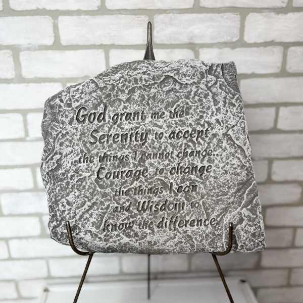Decorative stone plaque with an engraved Serenity Prayer on a metal stand