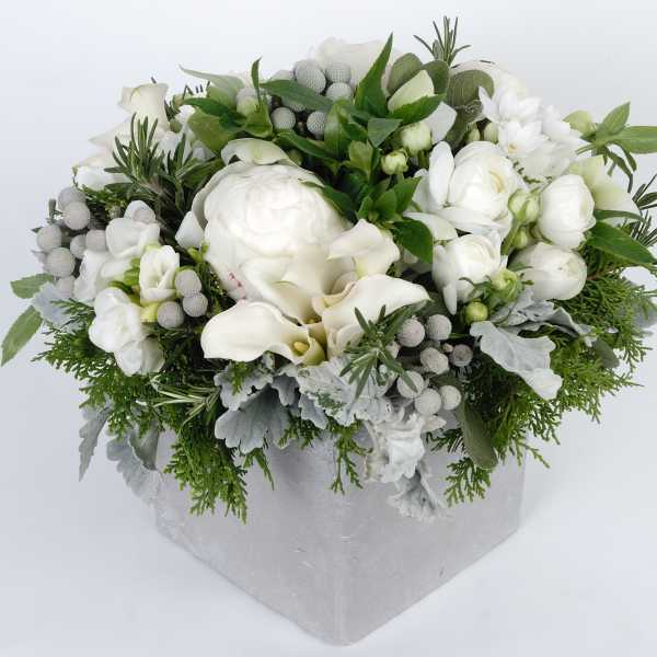 White floral arrangement in a silver box with greenery