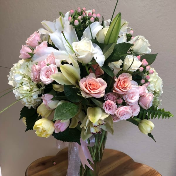 Bouquet of pink and white flowers in a clear glass vase