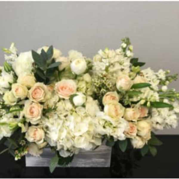 Low white and blush rose and hydrangea arrangement in a rectangular wooden box