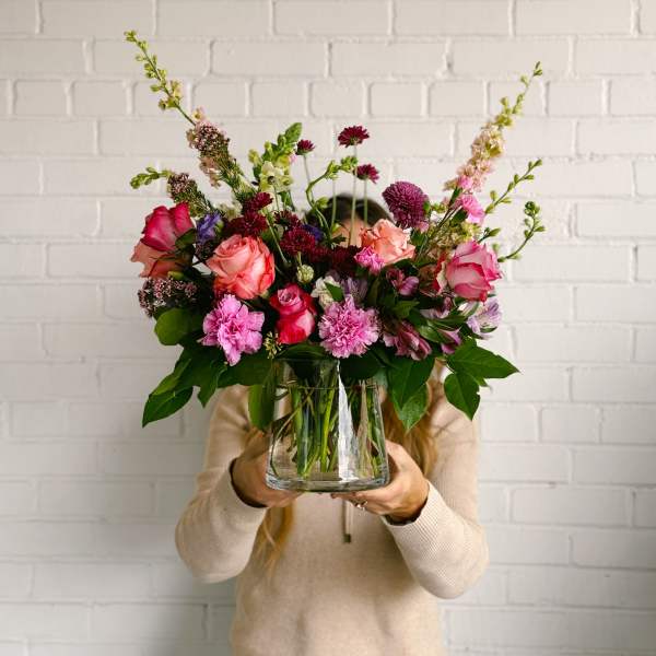 Mixed pink and purple bouquet in a clear glass vase