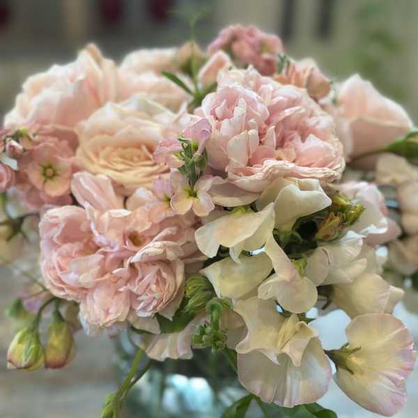 Blush pink and cream bouquet in a glass vase
