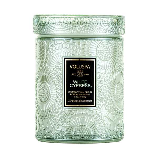 Green glass candle jar with a lid and label