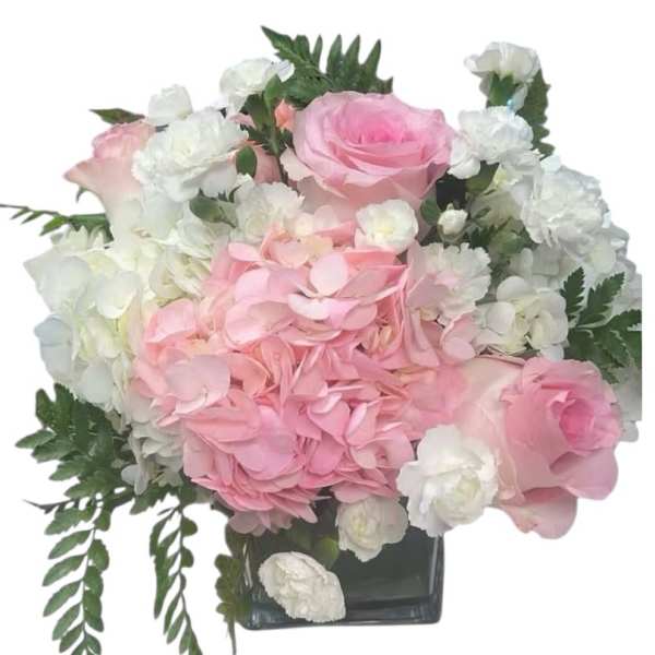 Pink roses and white hydrangeas in a square glass vase