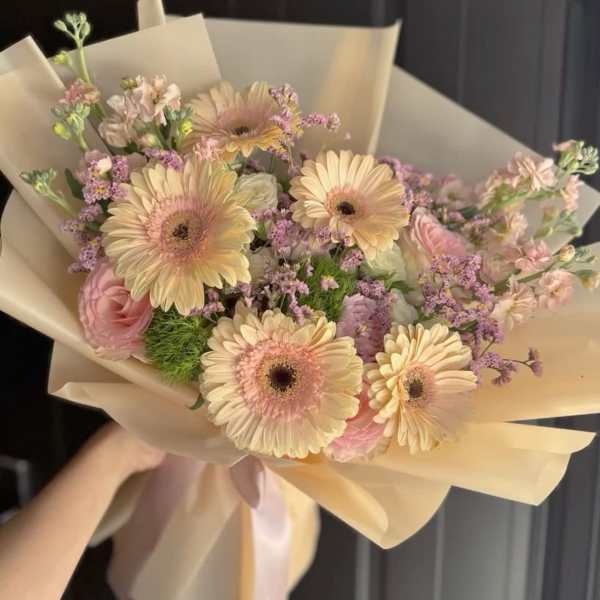 Bouquet of pale pink and cream gerbera daisies with pink roses