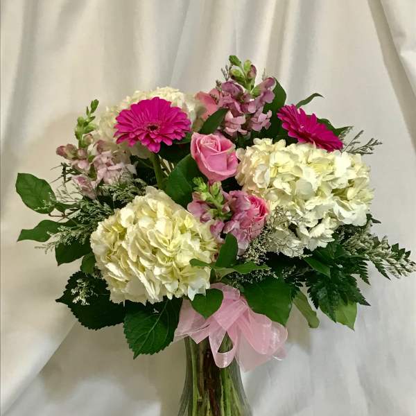 Pink and white mixed flower bouquet in a glass vase