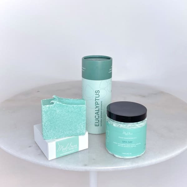 Spa gift set with soap, shower steamers, and sugar scrub in mint packaging