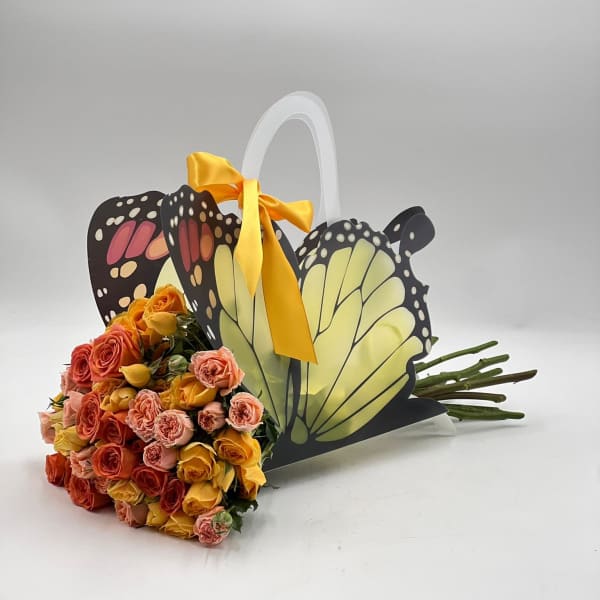 Bouquet of multicolored roses in a butterfly-shaped gift basket
