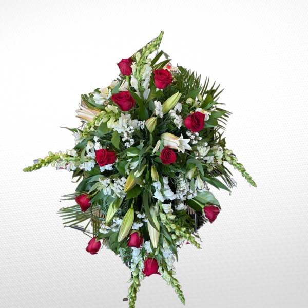 Standing floral spray with red roses, white lilies, and greenery