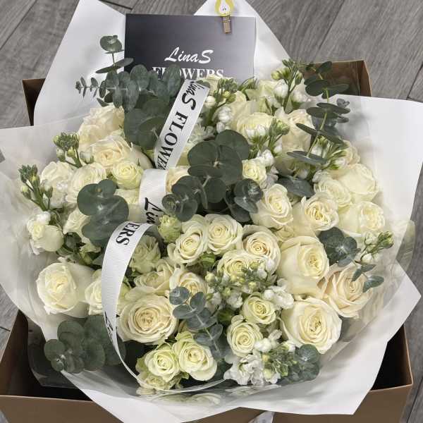 Bouquet of cream roses with eucalyptus in white wrap