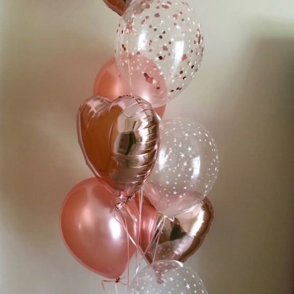 Cluster of pink and clear heart-shaped balloons with confetti
