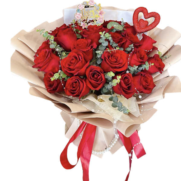 Bouquet of red roses with a birthday topper and heart decoration