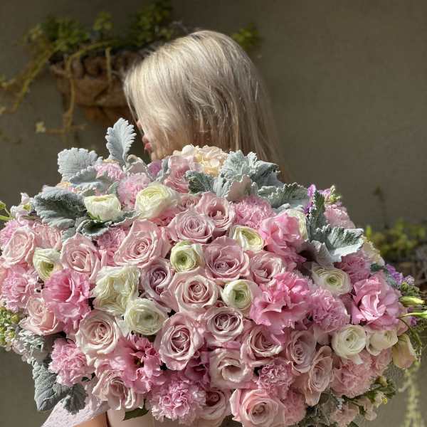 Large bouquet of pink and white roses with ruffled pink flowers