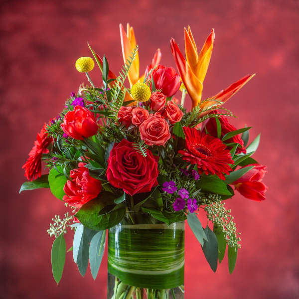 Bouquet of red and orange flowers in a glass vase
