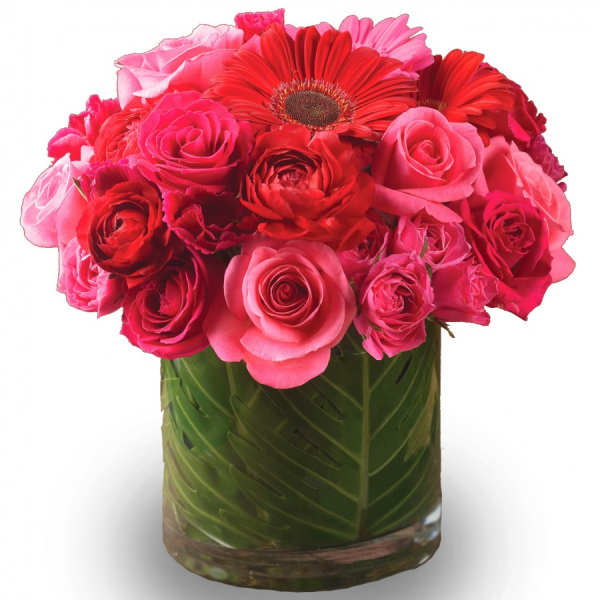 Pink and red roses with gerbera daisies in a glass vase