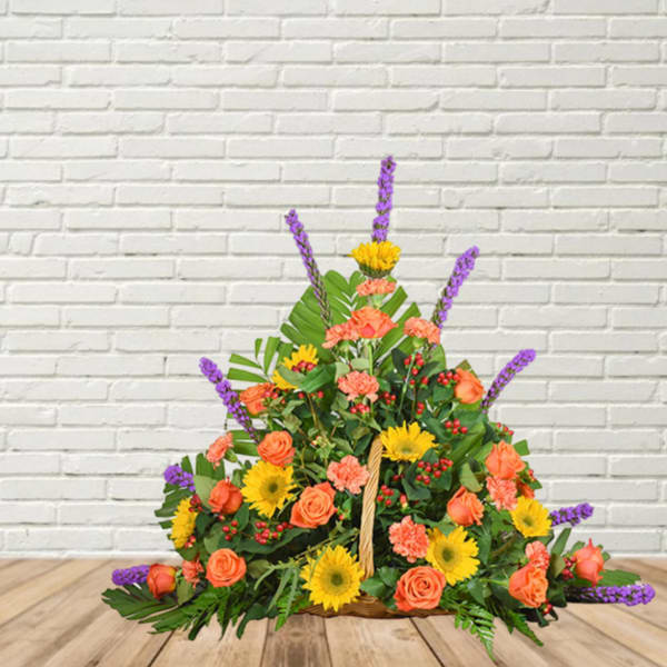 Basket arrangement of orange roses, yellow daisies, and purple spikes