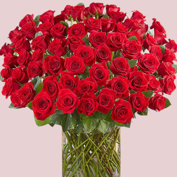 Large bouquet of red roses in a clear glass vase